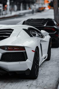 cars, super cars, luxury cars, lamborghini, corvette, black car, white car, sports cars, exotic cars, daytime, parked cars, car row, black lamborghini, white lamborghini, black corvette, high-end vehicles, automobile, car collection, outdoor