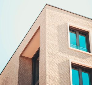 a large brick tower with a clock on the side of a building